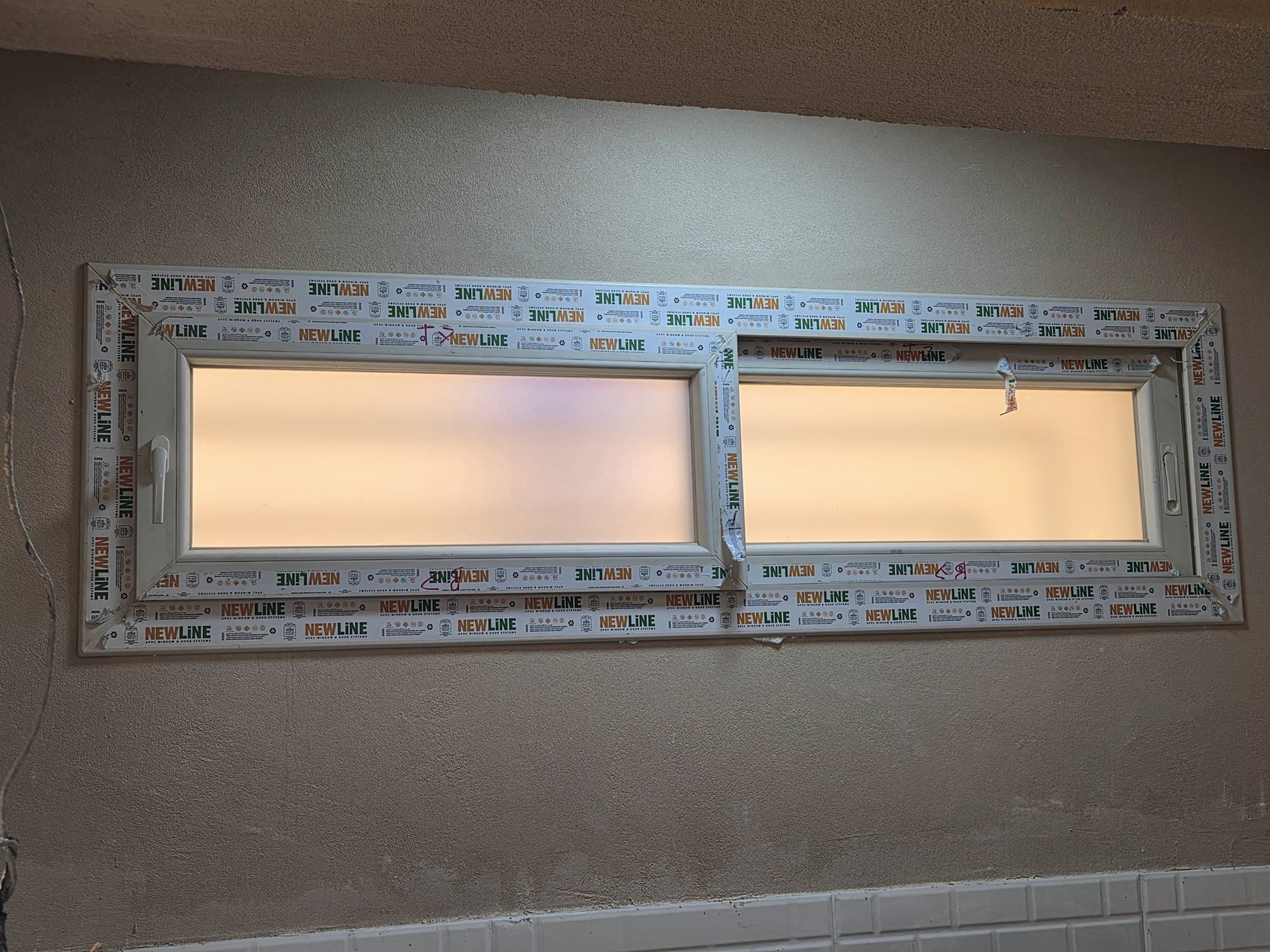 Newly installed uPVC window with its protective film still on