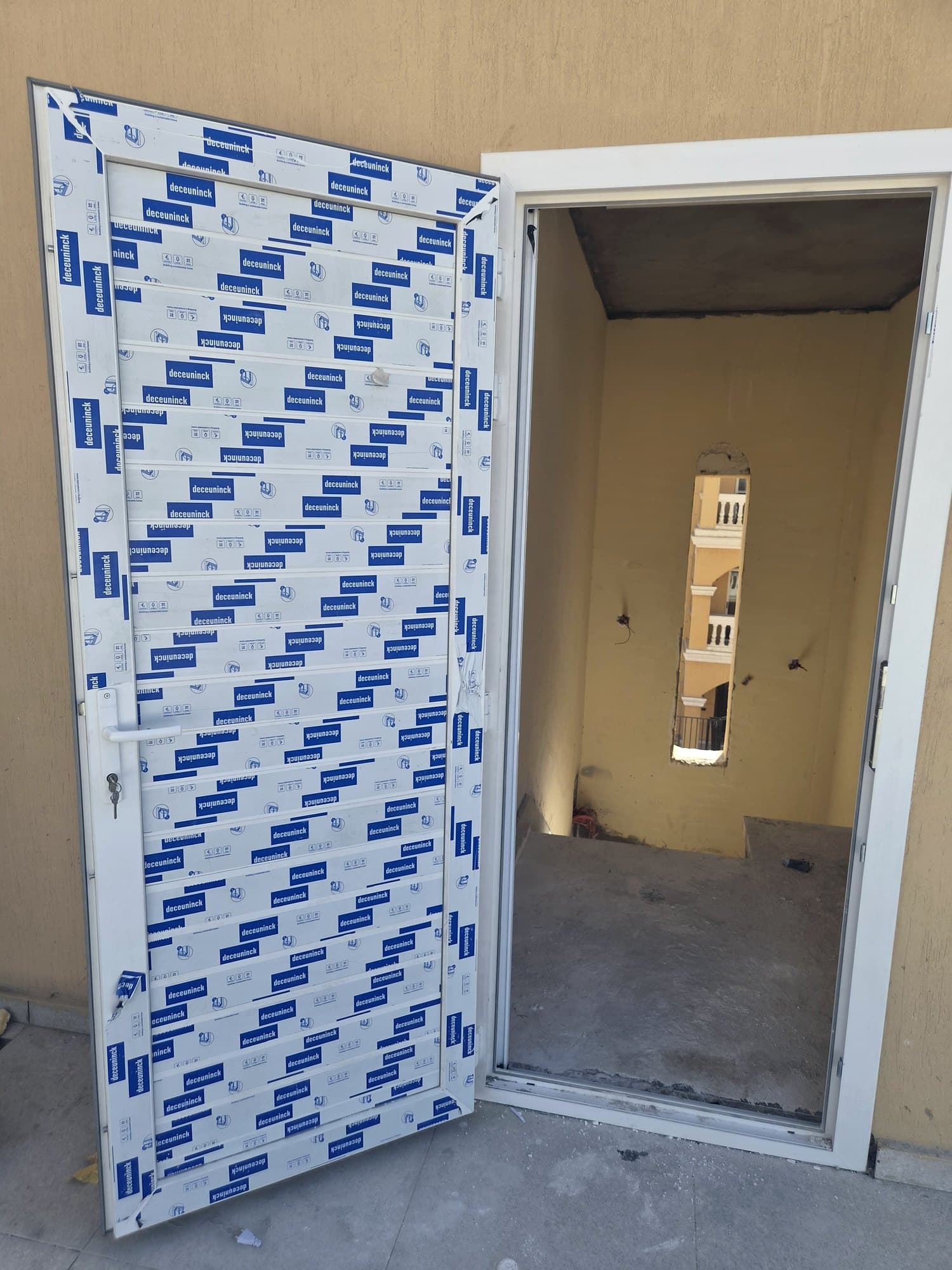 uPVC entrance door installed and still wrapped in protective film
