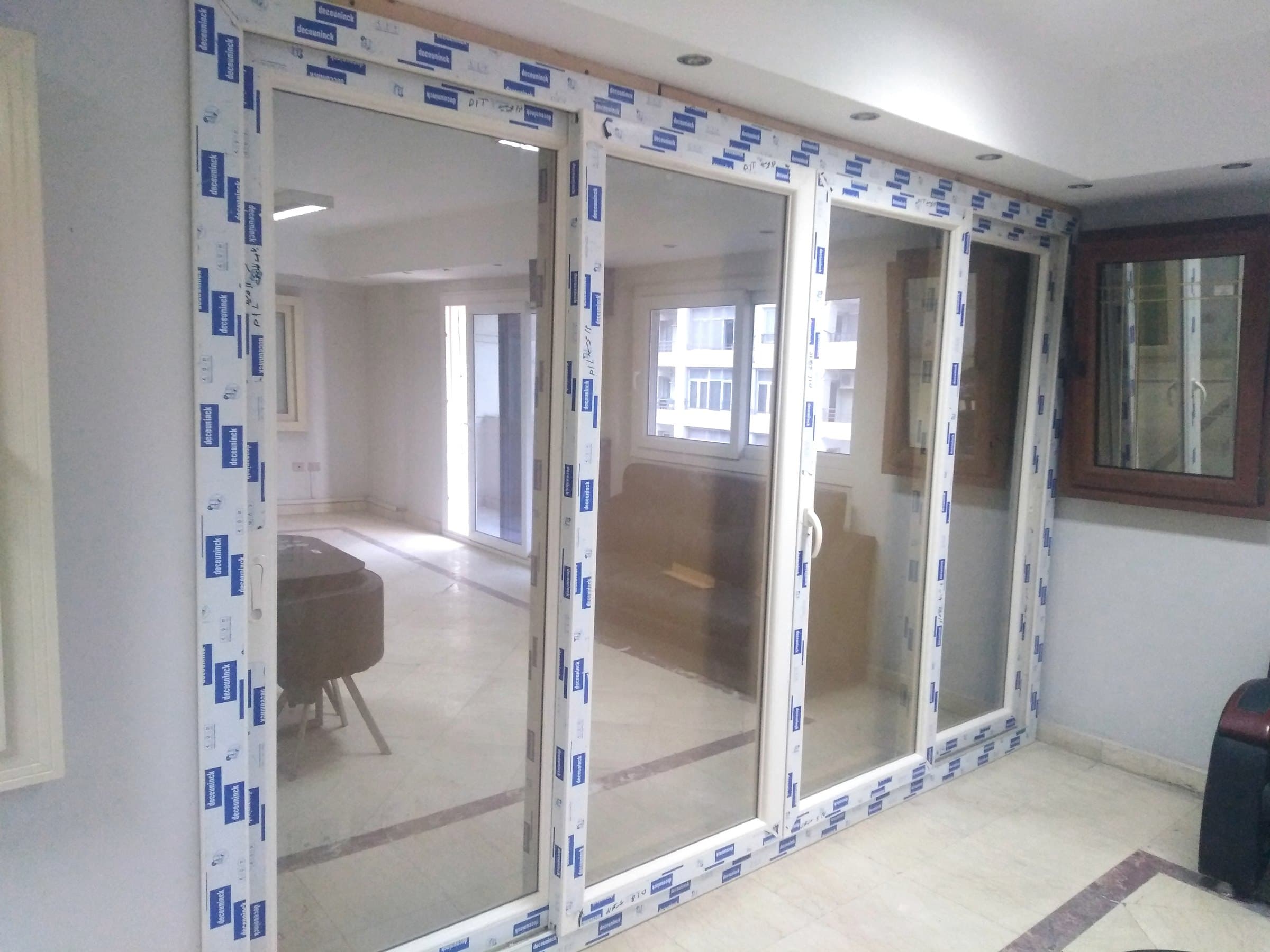 Wide four-panel sliding door between two living spaces