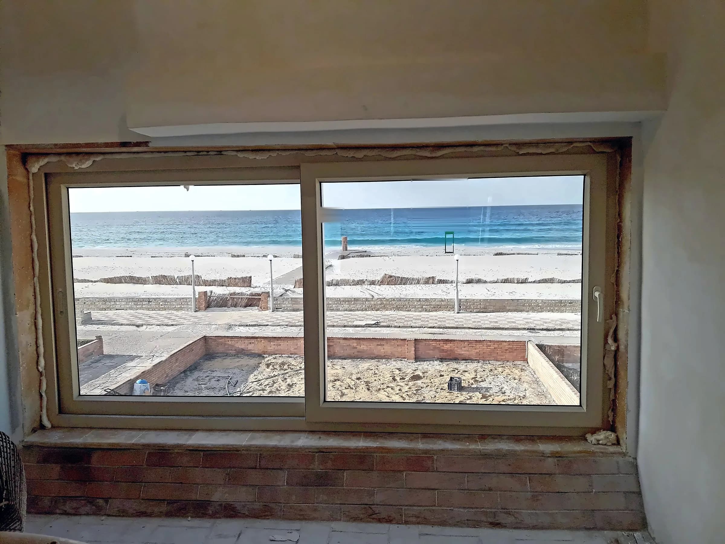 Sliding window framing the sea