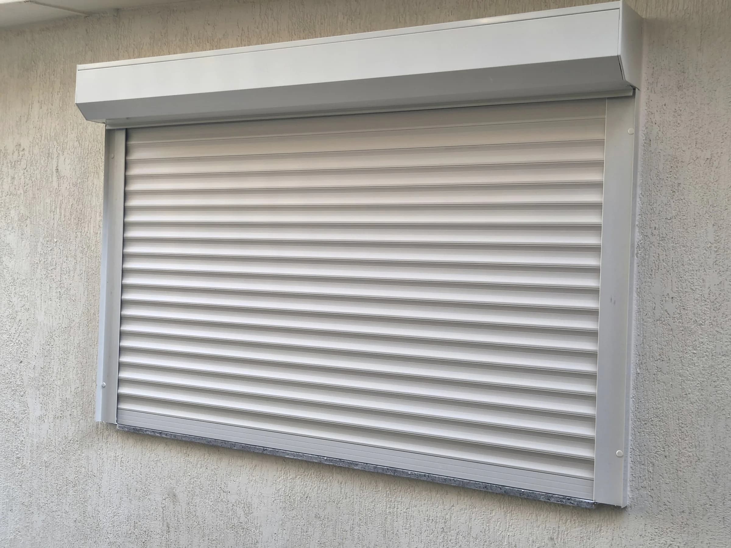 Closed roller shutter with a matching box on a villa window