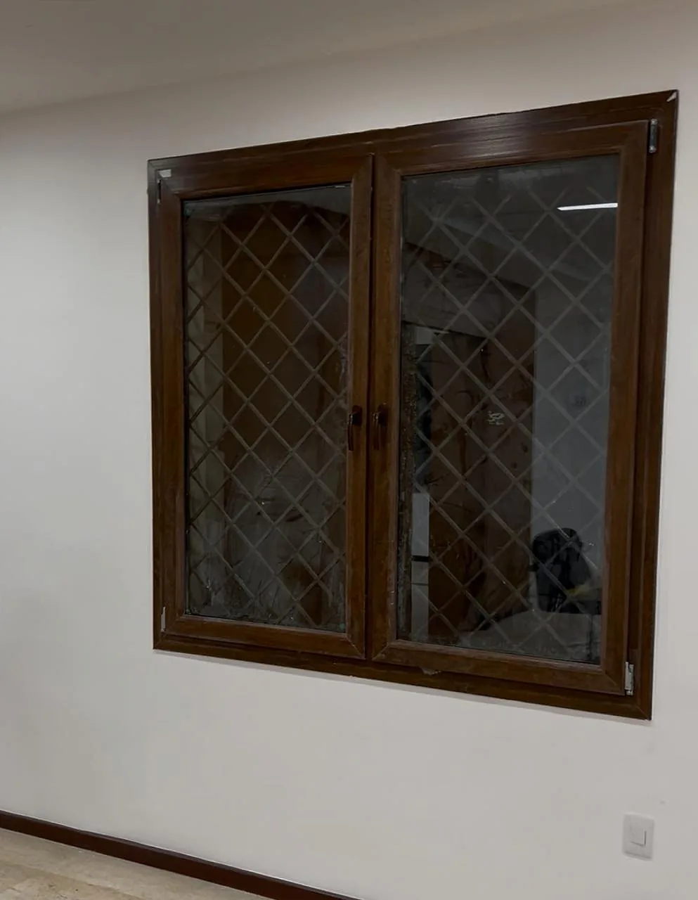 Wood-finish hinged window with diamond glazing bars