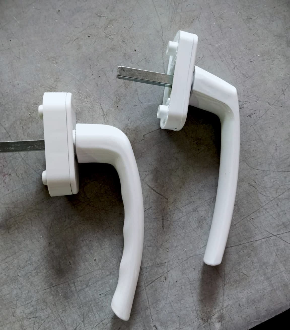 Two white window handles